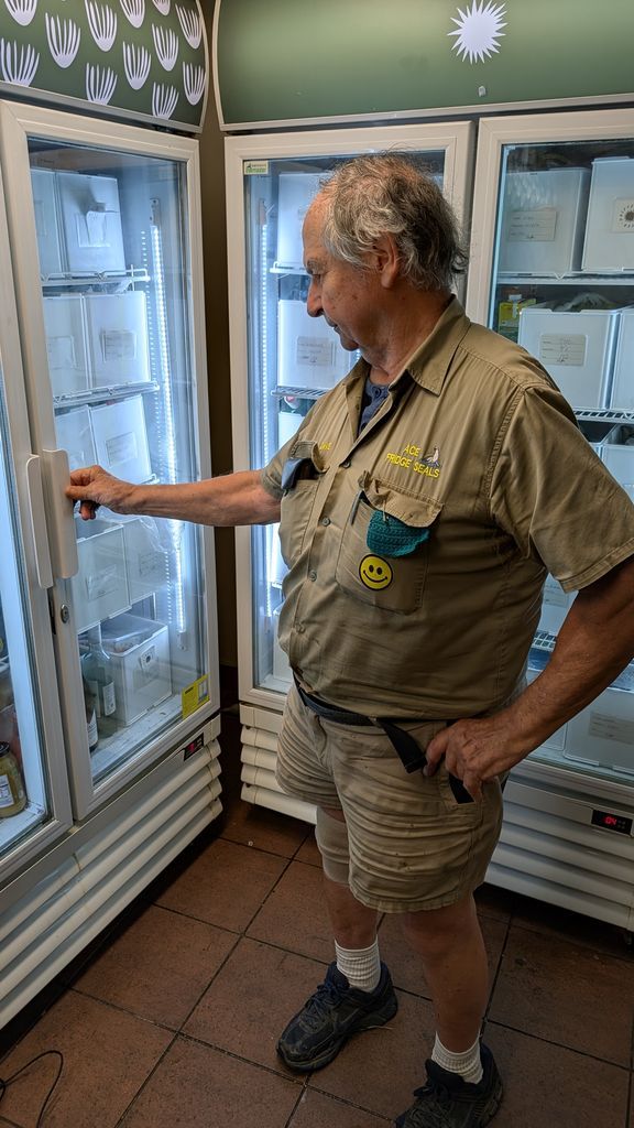 Man in Tan Outfit Reaching Into a Glass-door Freezer in a Store Aisle — Ace Fridge Door Seals In Cairns, QLD