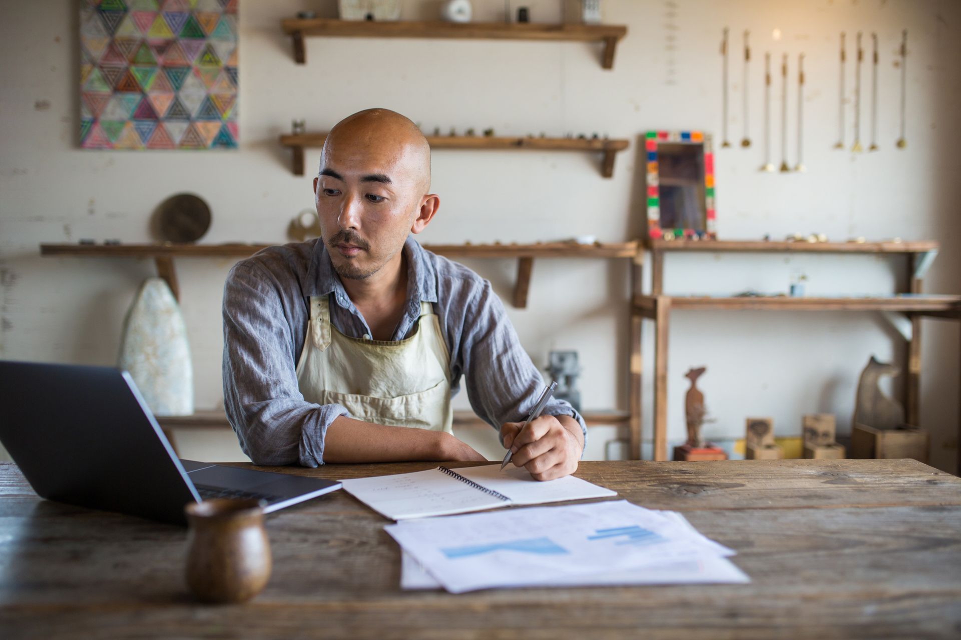 A shopkeeper doing his monthly financial planning and bookkeeping.