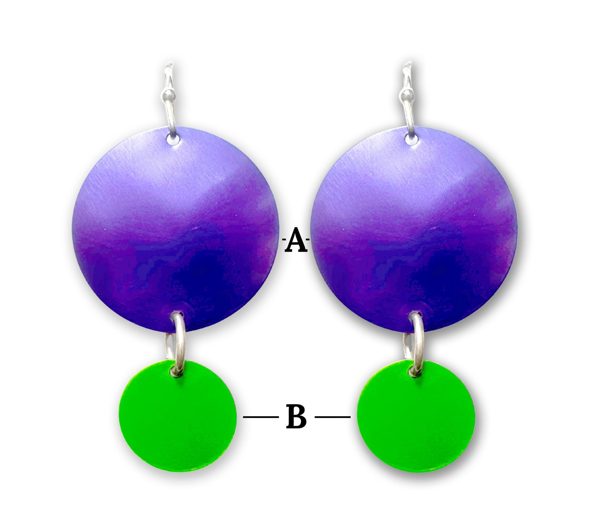 Woman wearing purple and green earrings, silver beaded necklace, and patterned blue scarf.