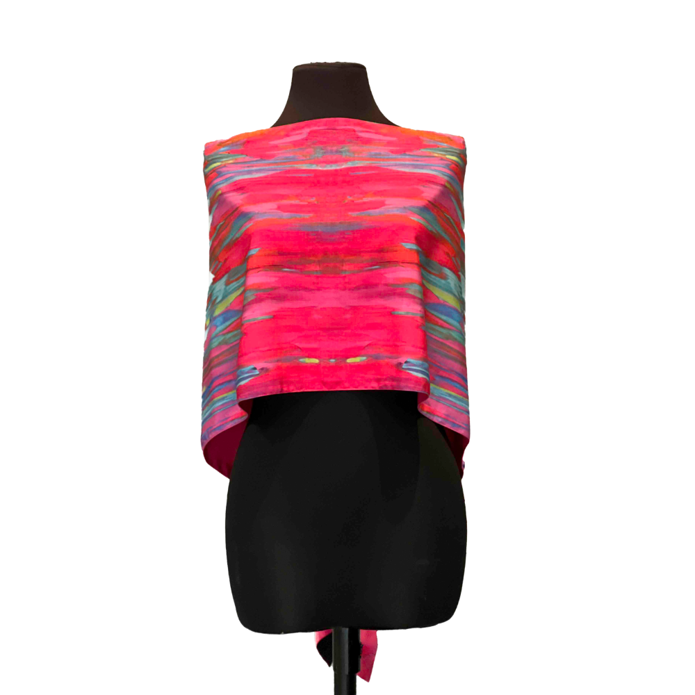 Pink and blue patterned scarf draped over a black mannequin.