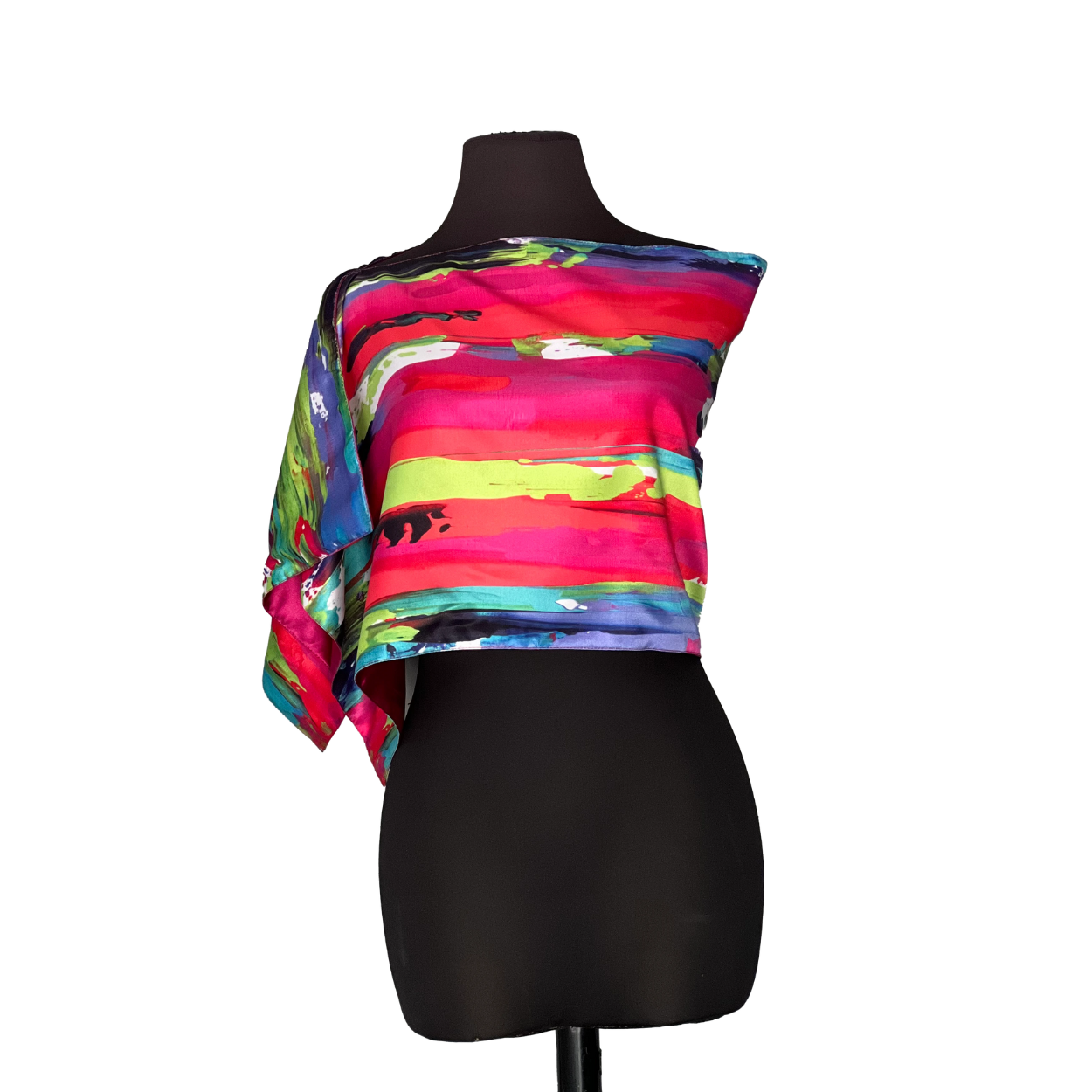 Abstract-print, one-shoulder top on a black mannequin. Bright pink, red, blue, and green colors.