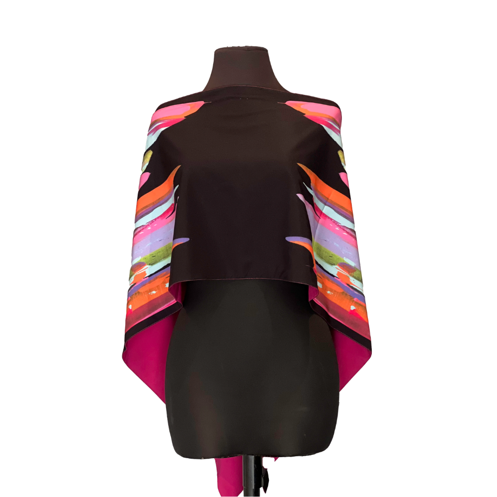 Black silk cape with a colorful stripe design on a mannequin.