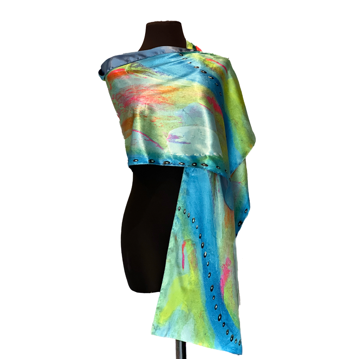 Silk scarf in blue, green, and pink, draped over a mannequin.