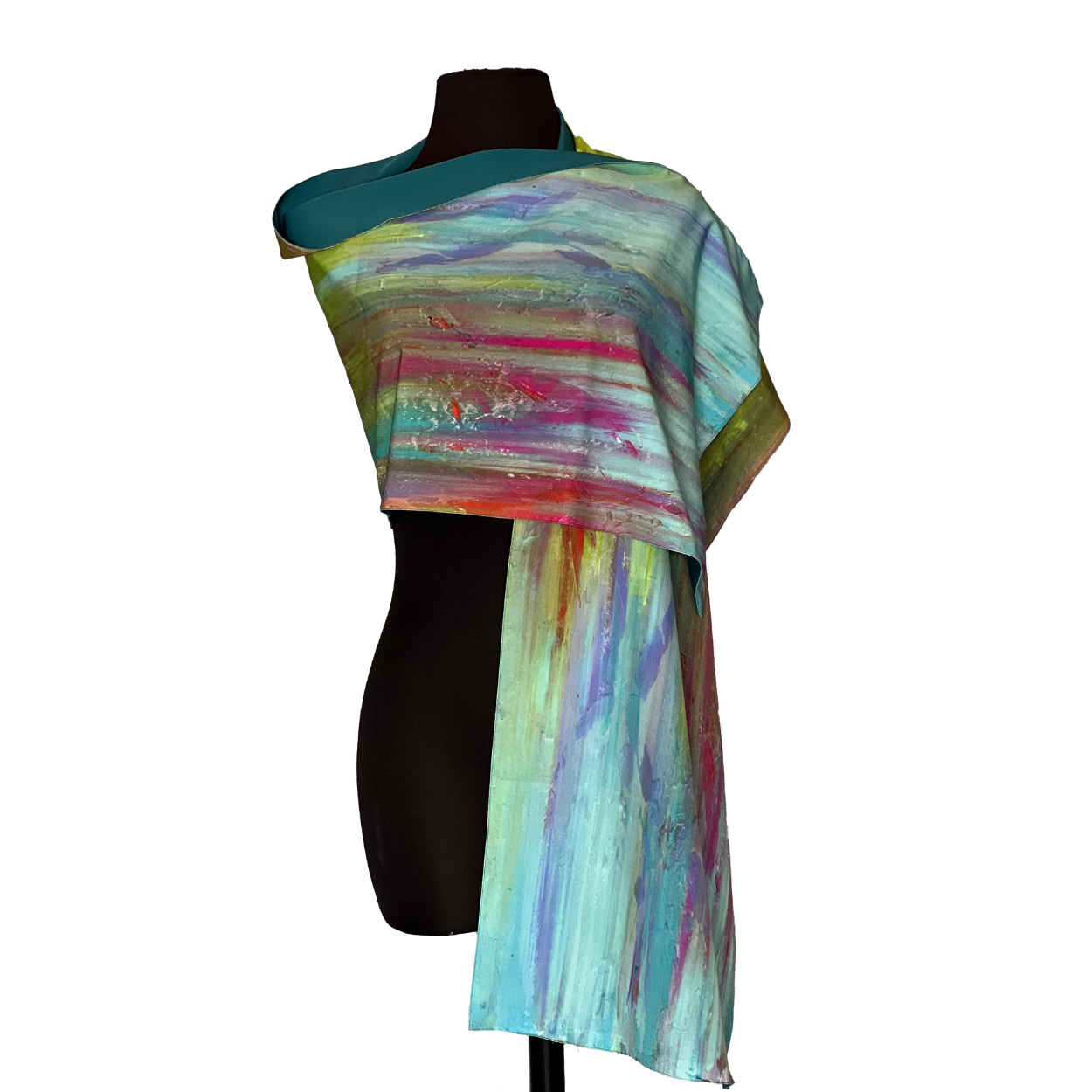 Abstract silk scarf draped on a black mannequin, featuring a blend of teal, pink, and yellow.