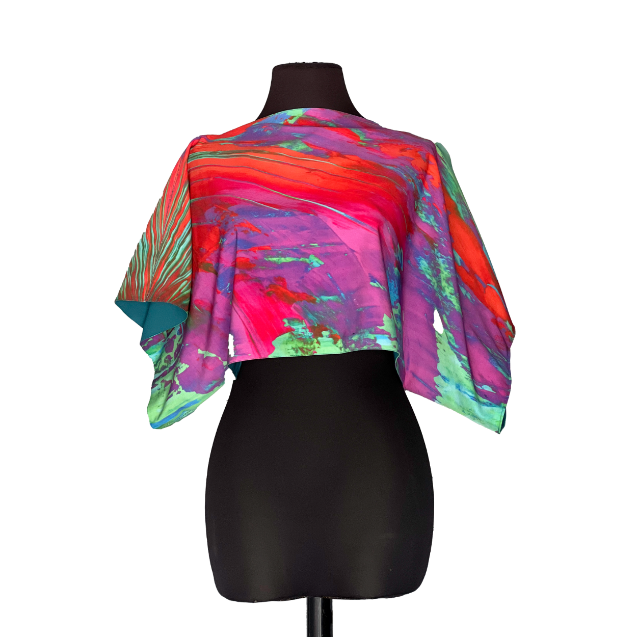 Crop top on a black mannequin, colorful abstract design with red, pink, purple, and green hues.