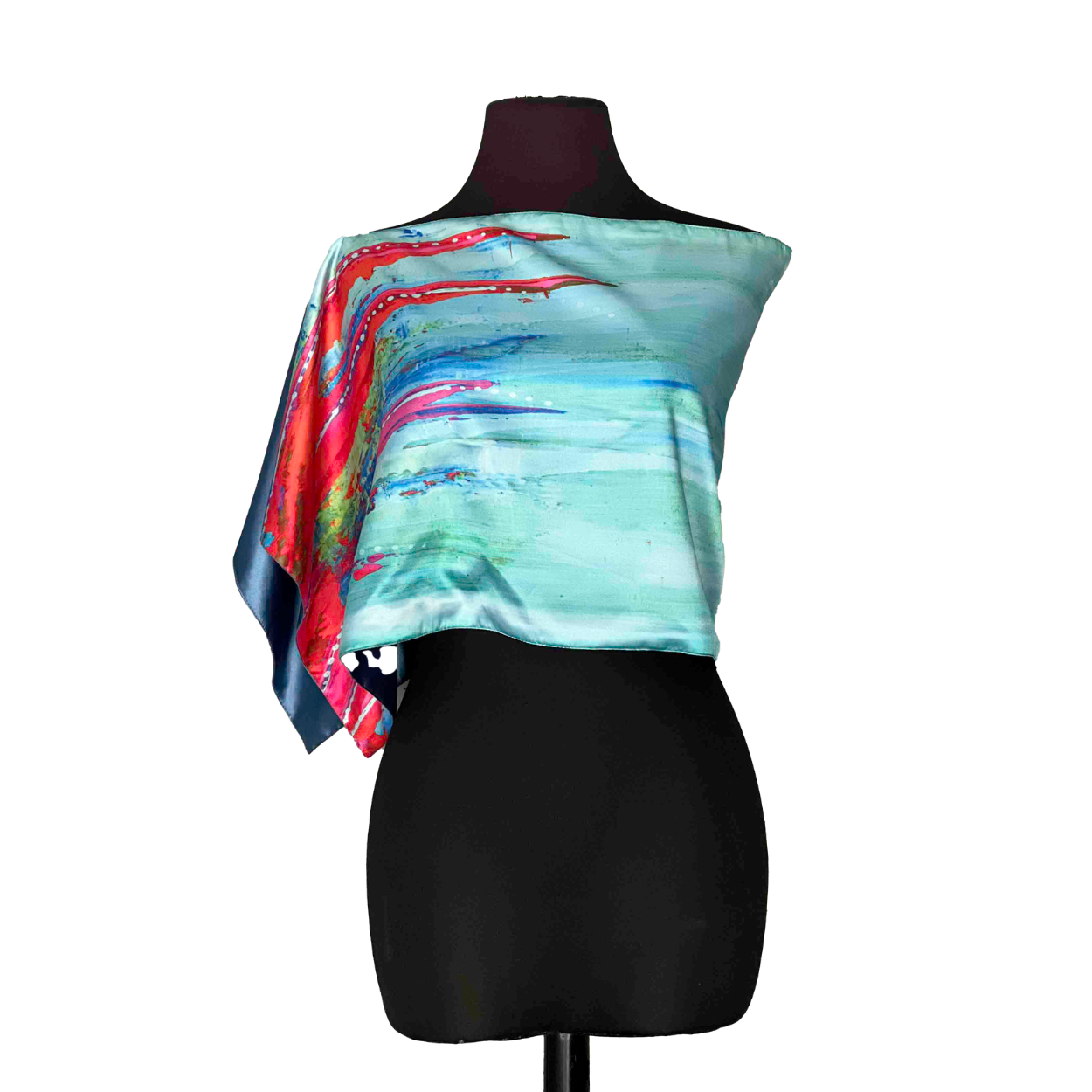 Silk scarf with colorful abstract design draped on a black mannequin.