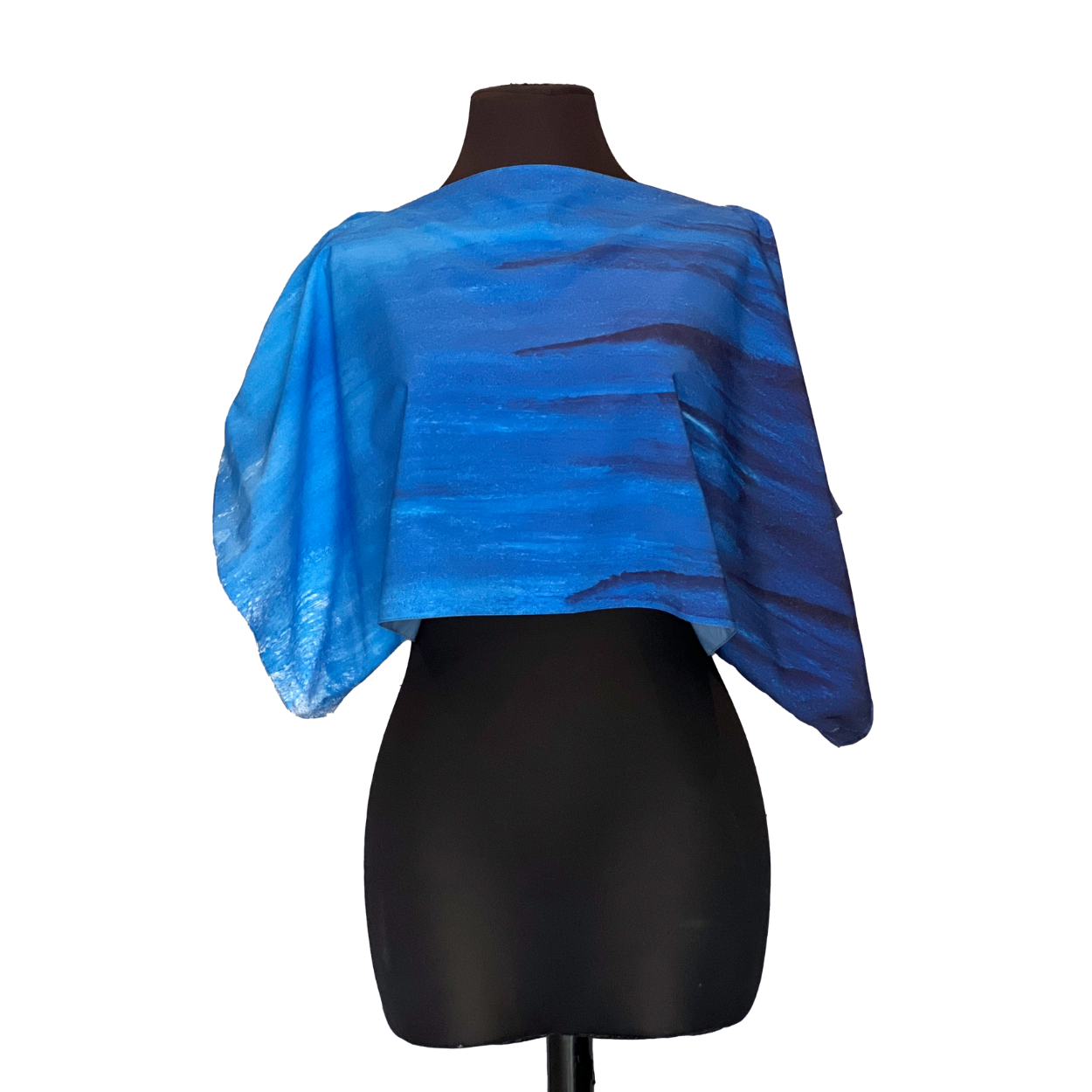Blue and black patterned shoulder wrap on a black mannequin, with a blue watercolor effect.