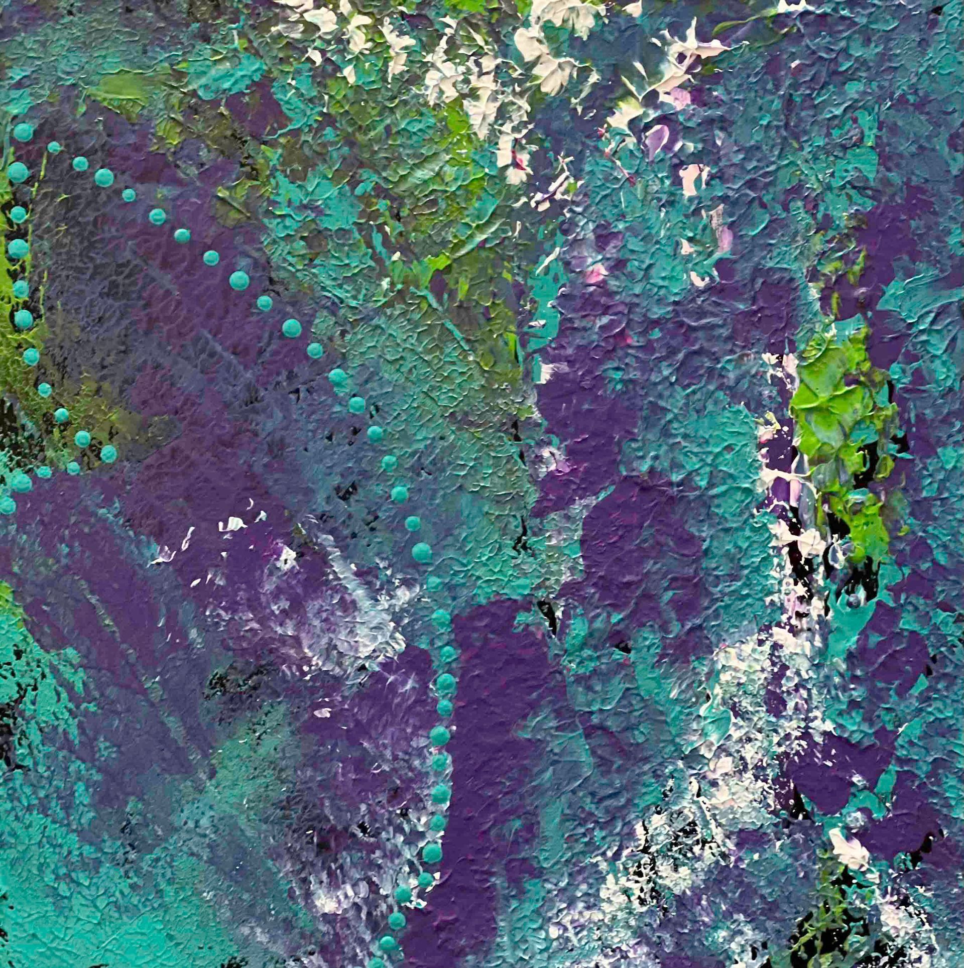 Silk scarf on a black mannequin. Scarf has colorful abstract design: blue, green, orange, and black circular shapes.