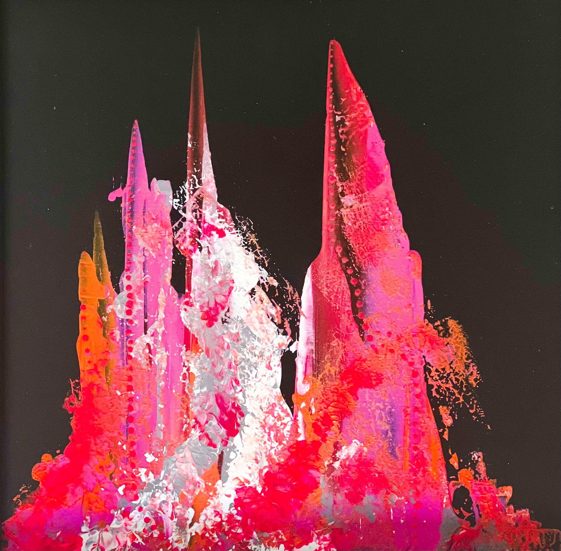 Black mannequin wearing a scarf with a colorful abstract design in shades of red, pink, and white.