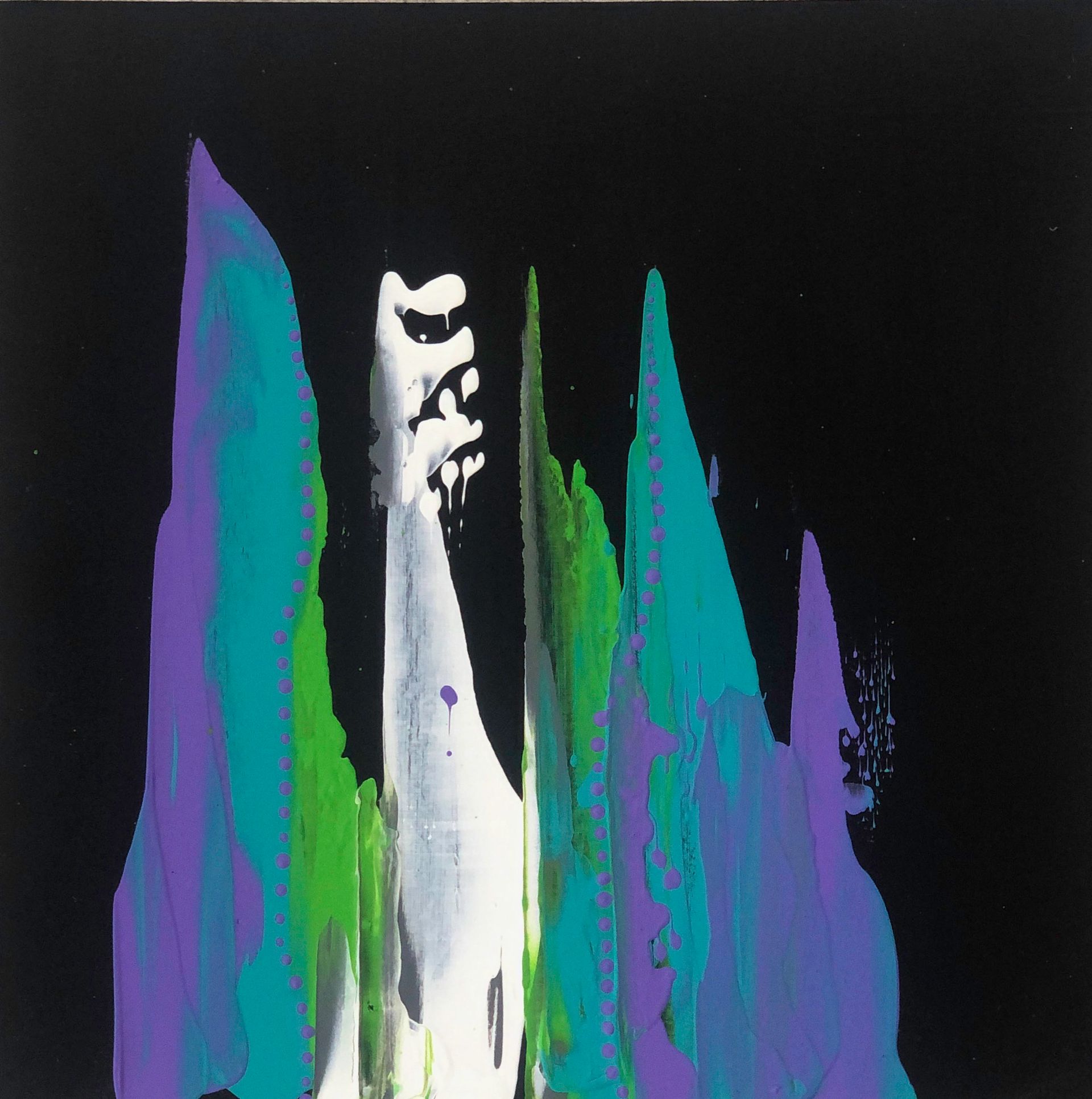 A colorful, abstract scarf draped on a black mannequin; blues, greens, and white paint-like strokes.