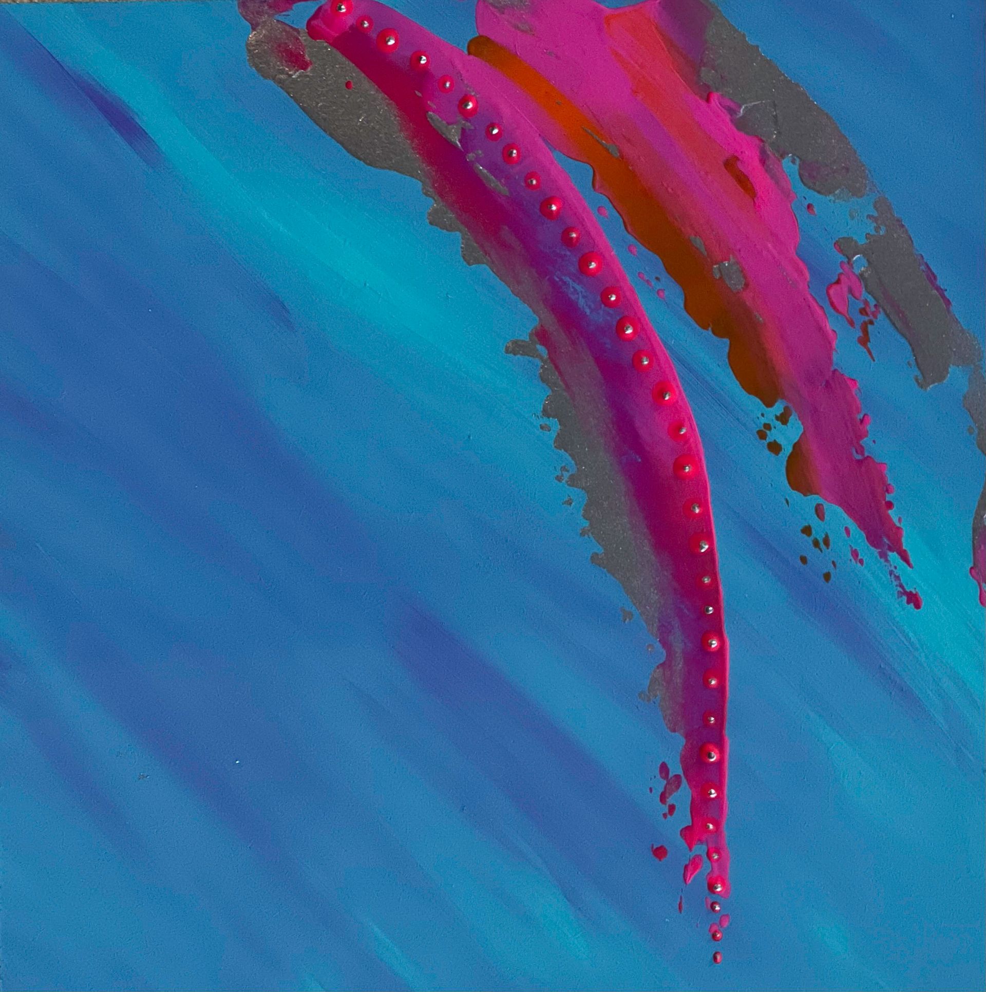 Blue scarf with pink brushstroke design draped on a mannequin.