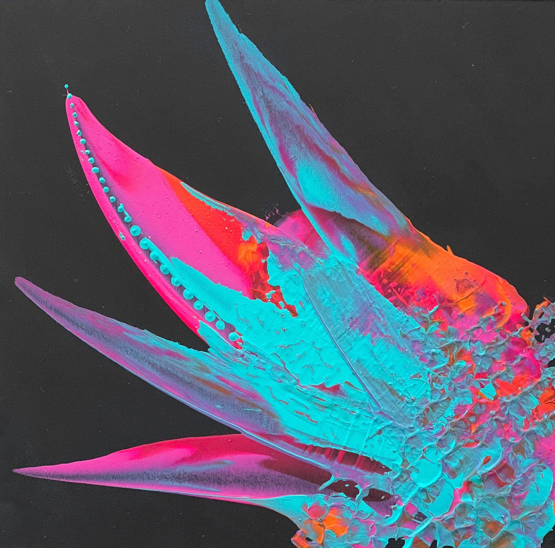 Black dress form draped with a colorful scarf in blue, pink, and red abstract design.