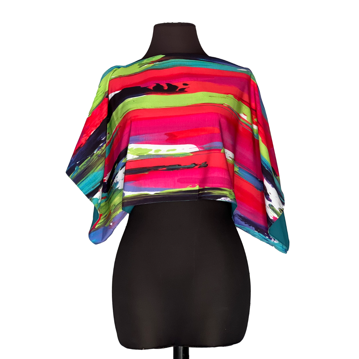 Colorful abstract print poncho on a black mannequin.