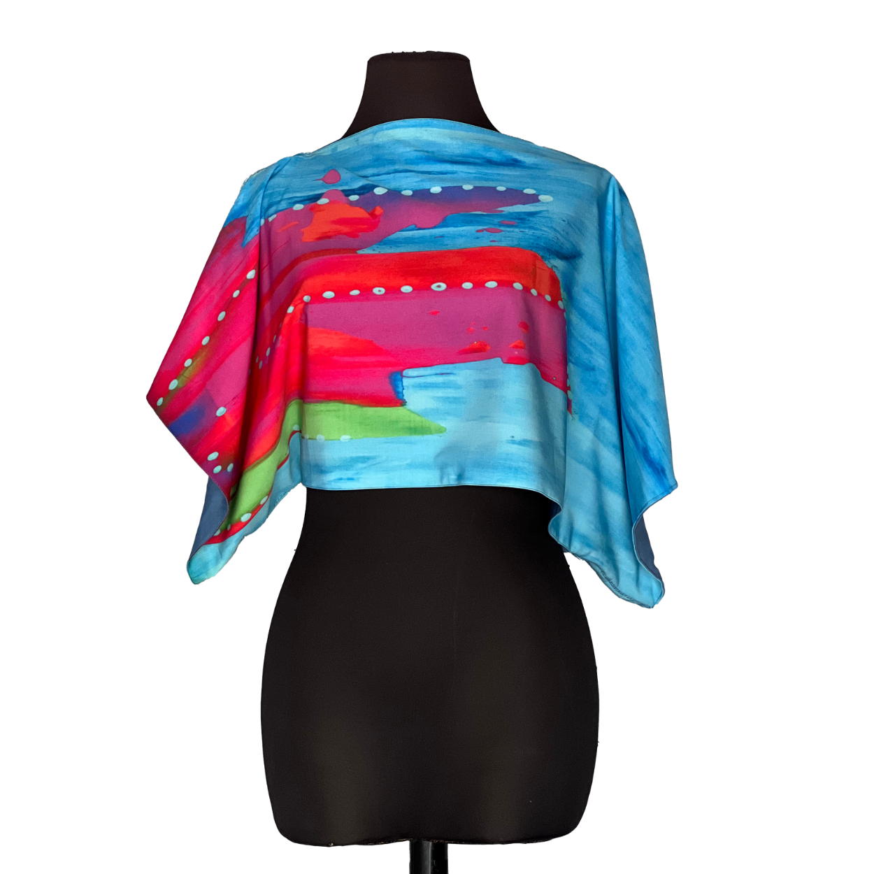 Colorful abstract silk crop top on a black mannequin.