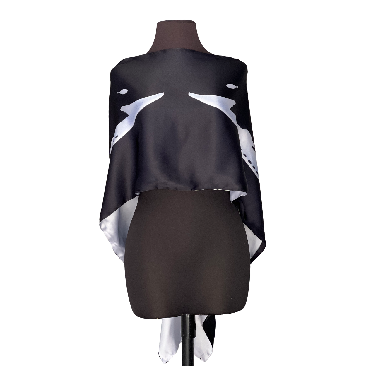 Black and white patterned shawl draped on a mannequin.