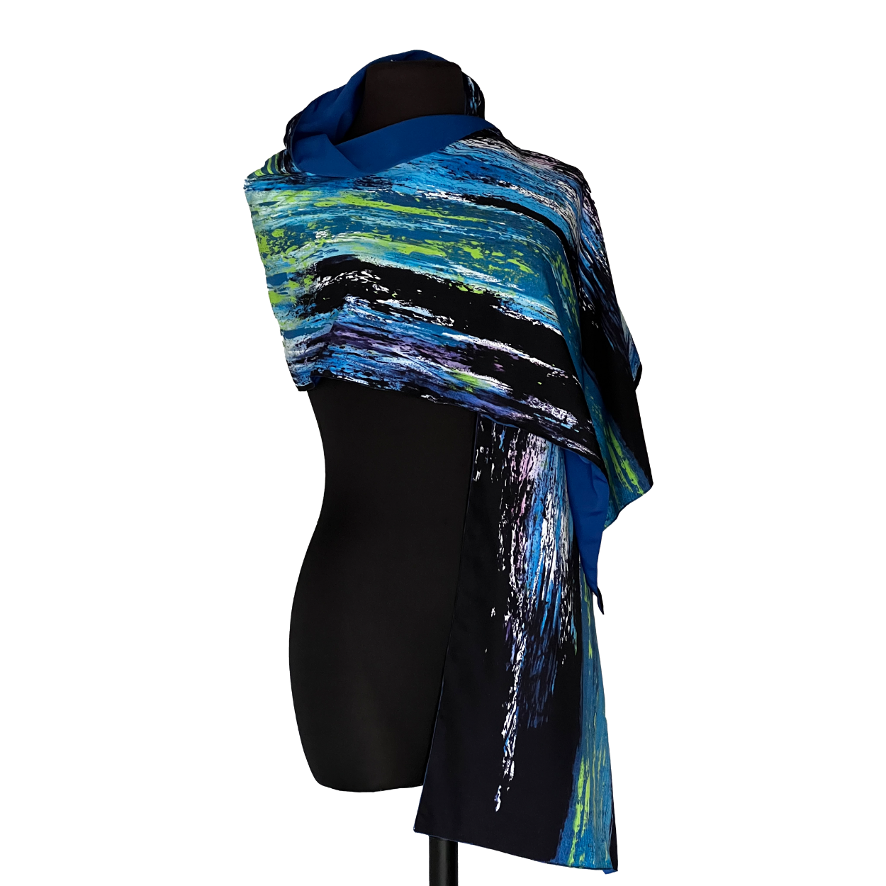 Blue, black, and green patterned scarf draped over a black mannequin.