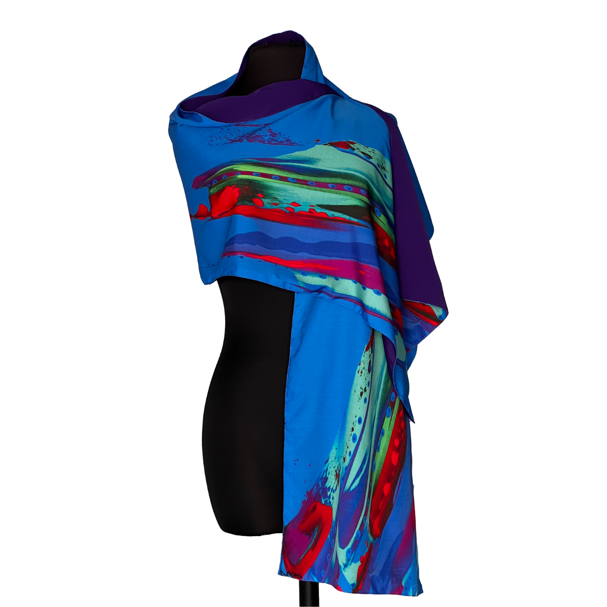 Blue scarf with abstract design of red, turquoise, and purple brushstrokes draped over a black mannequin.