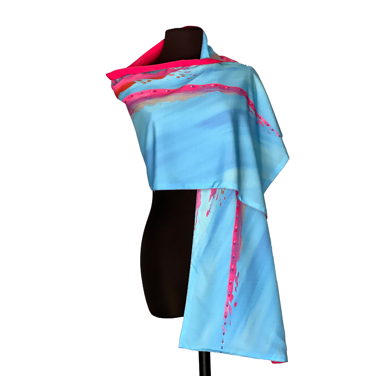 Blue scarf with pink brushstroke design draped on a mannequin.