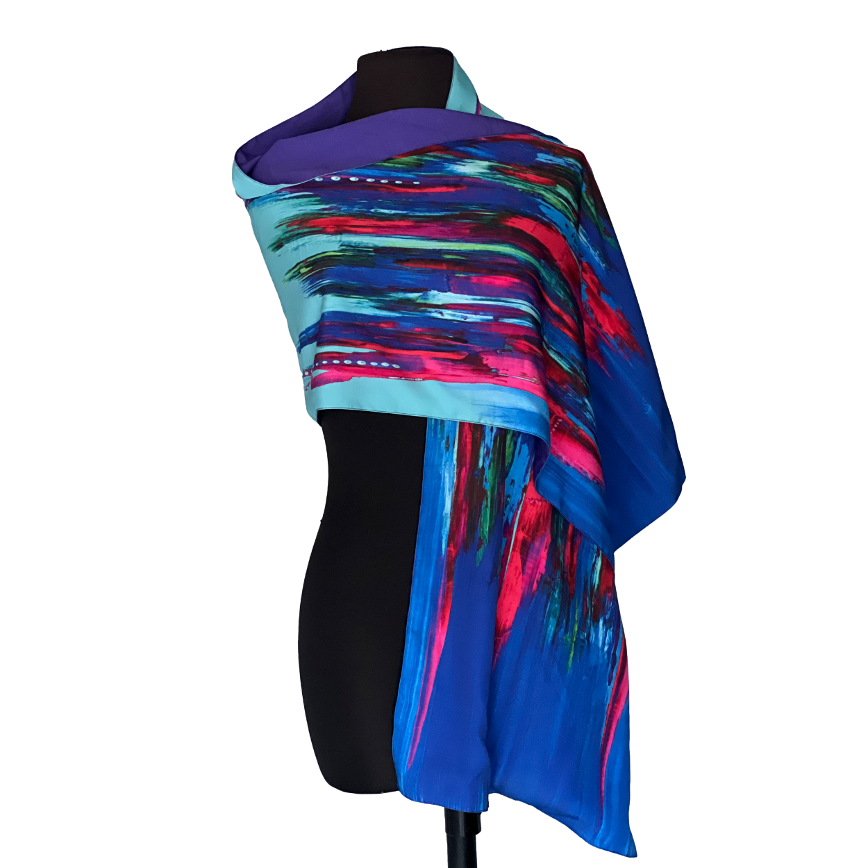 Blue, pink, and turquoise abstract patterned silk scarf draped over a black mannequin.