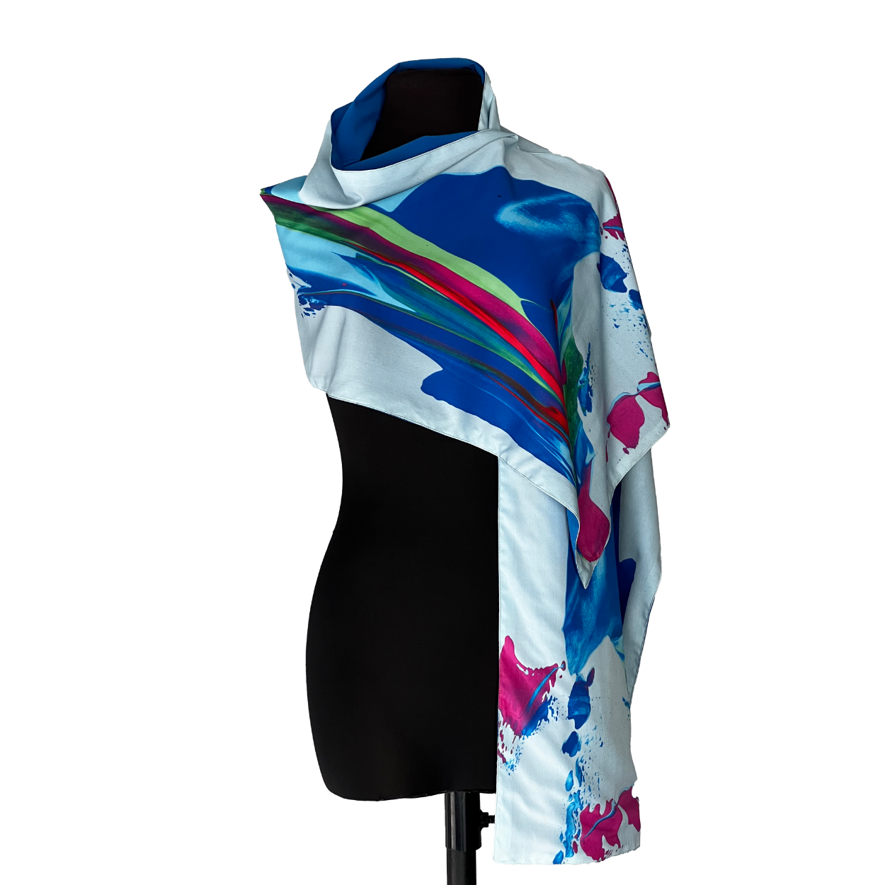 Scarf draped over a black mannequin; light blue background with abstract blue and pink paint strokes.