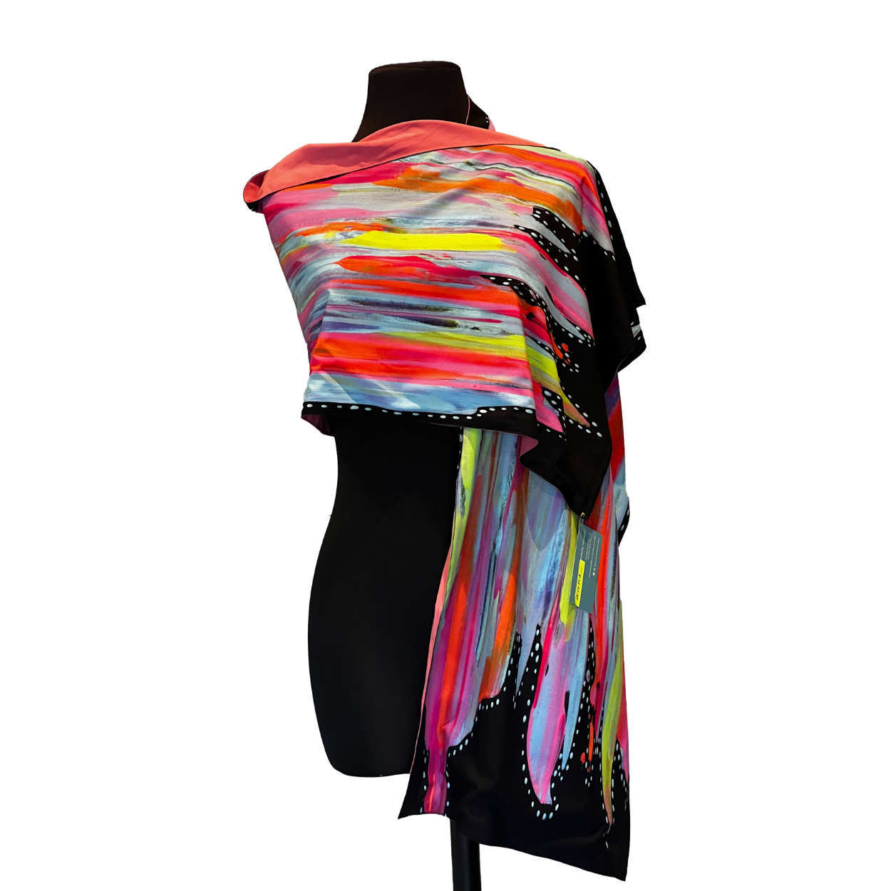 Colorful, abstract silk scarf draped on a black mannequin. Bright brushstrokes, black background, and small white embellishments.