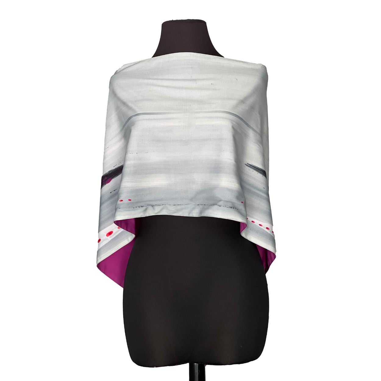 A light gray and pink shawl draped on a black mannequin, with gray and purple stripes.