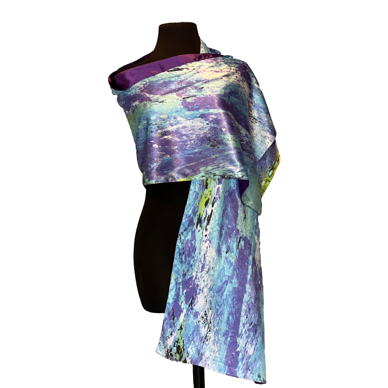 Silk scarf draped on a black mannequin, featuring a blue, white, and purple abstract design.