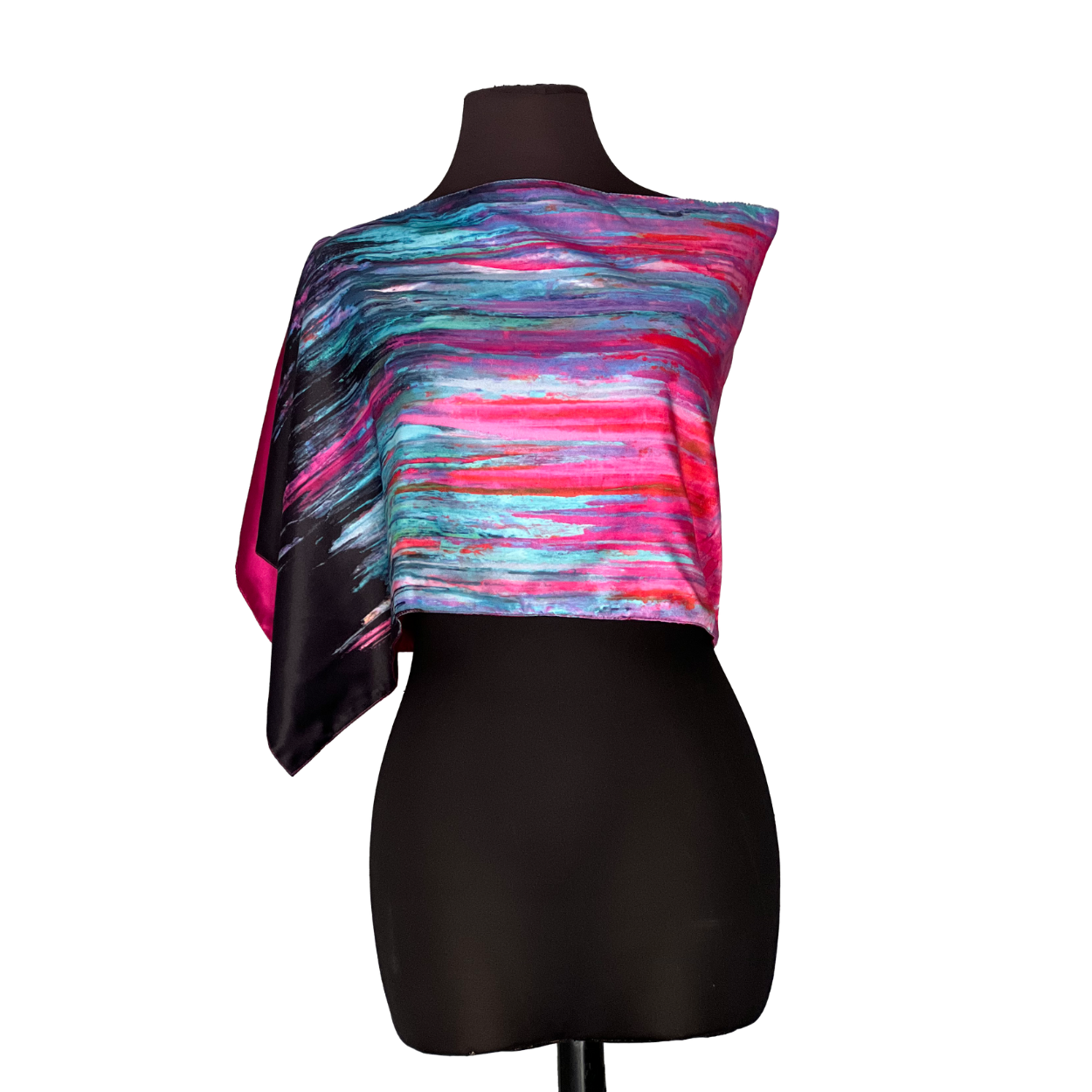Silk scarf with a colorful abstract pattern draped over a black mannequin.