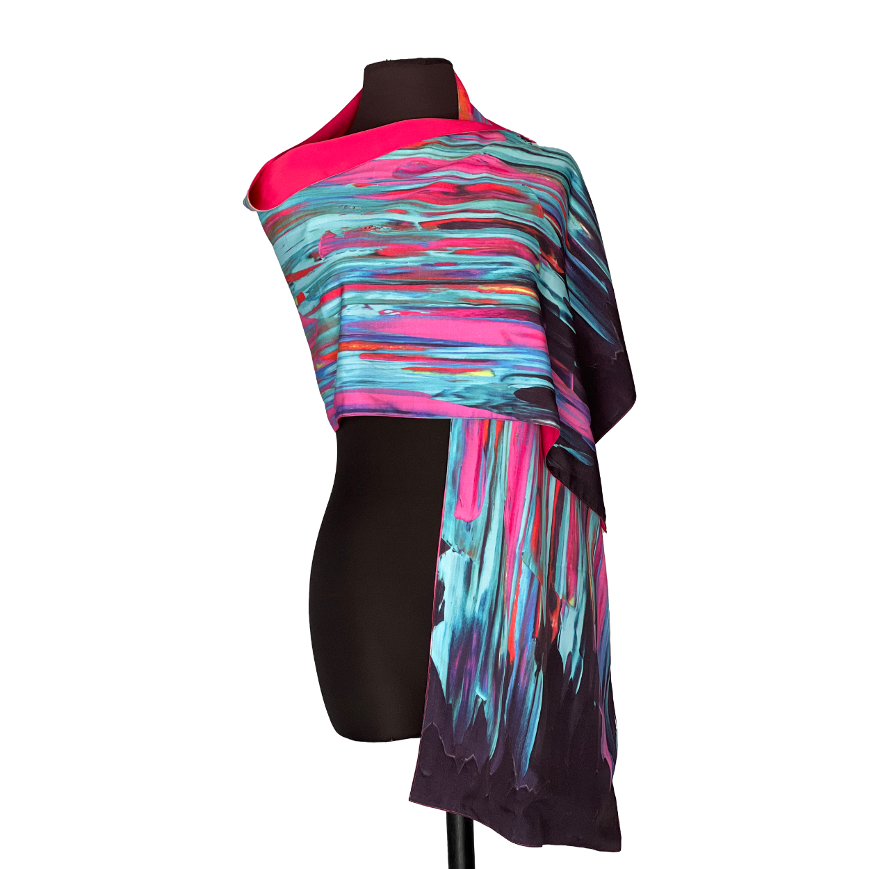 Abstract-patterned scarf draped over a black mannequin. Colors include pink, blue, and black.