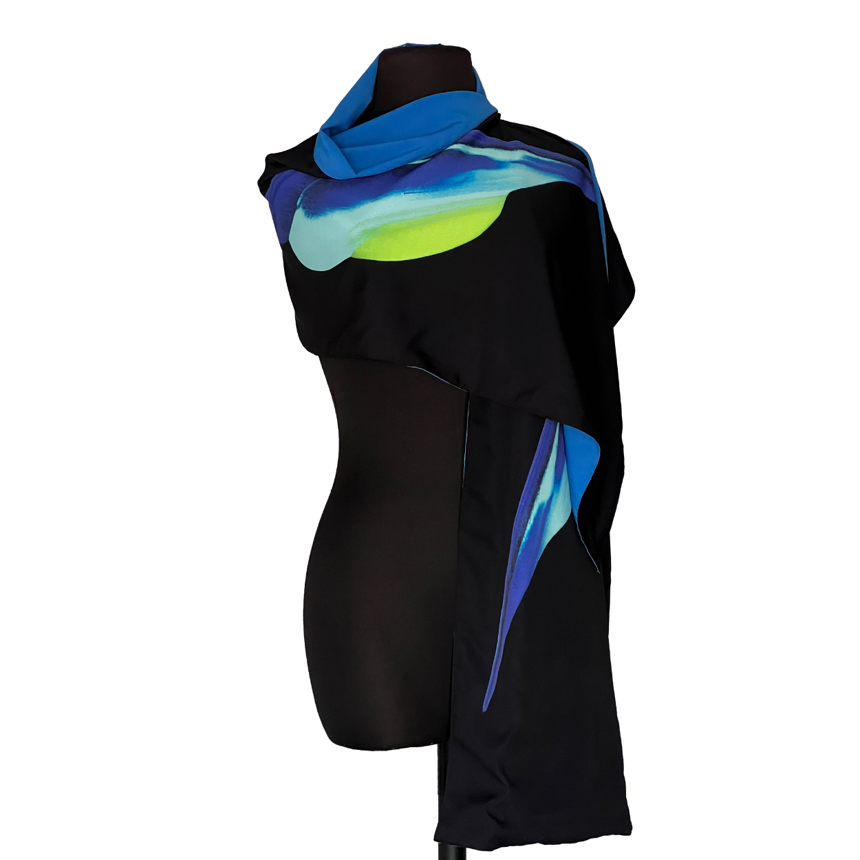 Black shawl draped on a black mannequin, with blue, turquoise, and yellow abstract design.