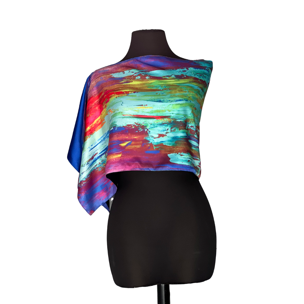 Colorful abstract print asymmetrical top on a black mannequin.