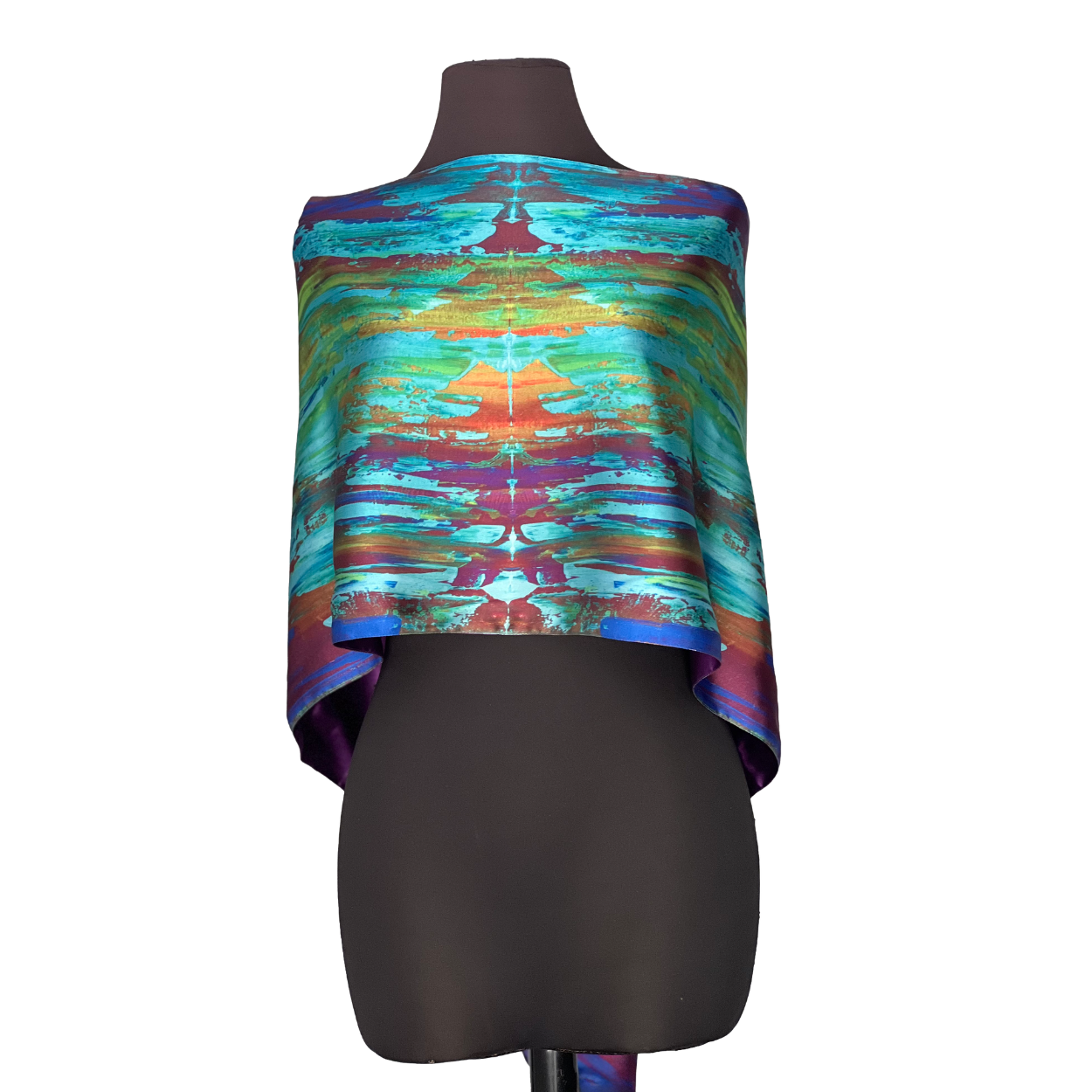 Silk scarf with colorful abstract design draped over a mannequin.
