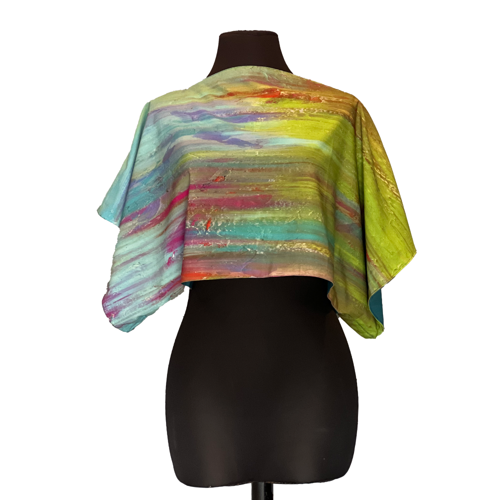 Crop top with colorful abstract painted pattern on black mannequin.