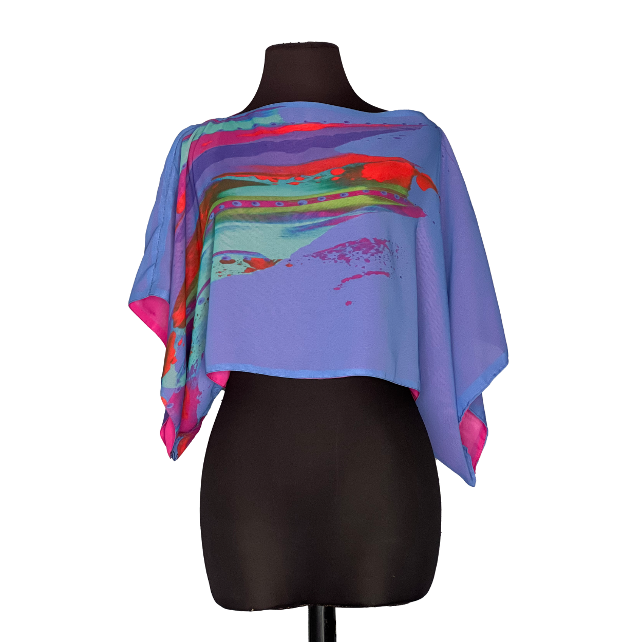 Blue poncho with abstract colorful print on a black mannequin.