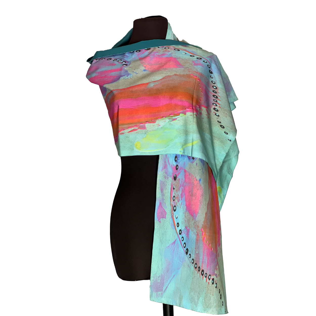 Abstract-patterned scarf draped on a mannequin, with pink, orange, and blue watercolor-like swashes.