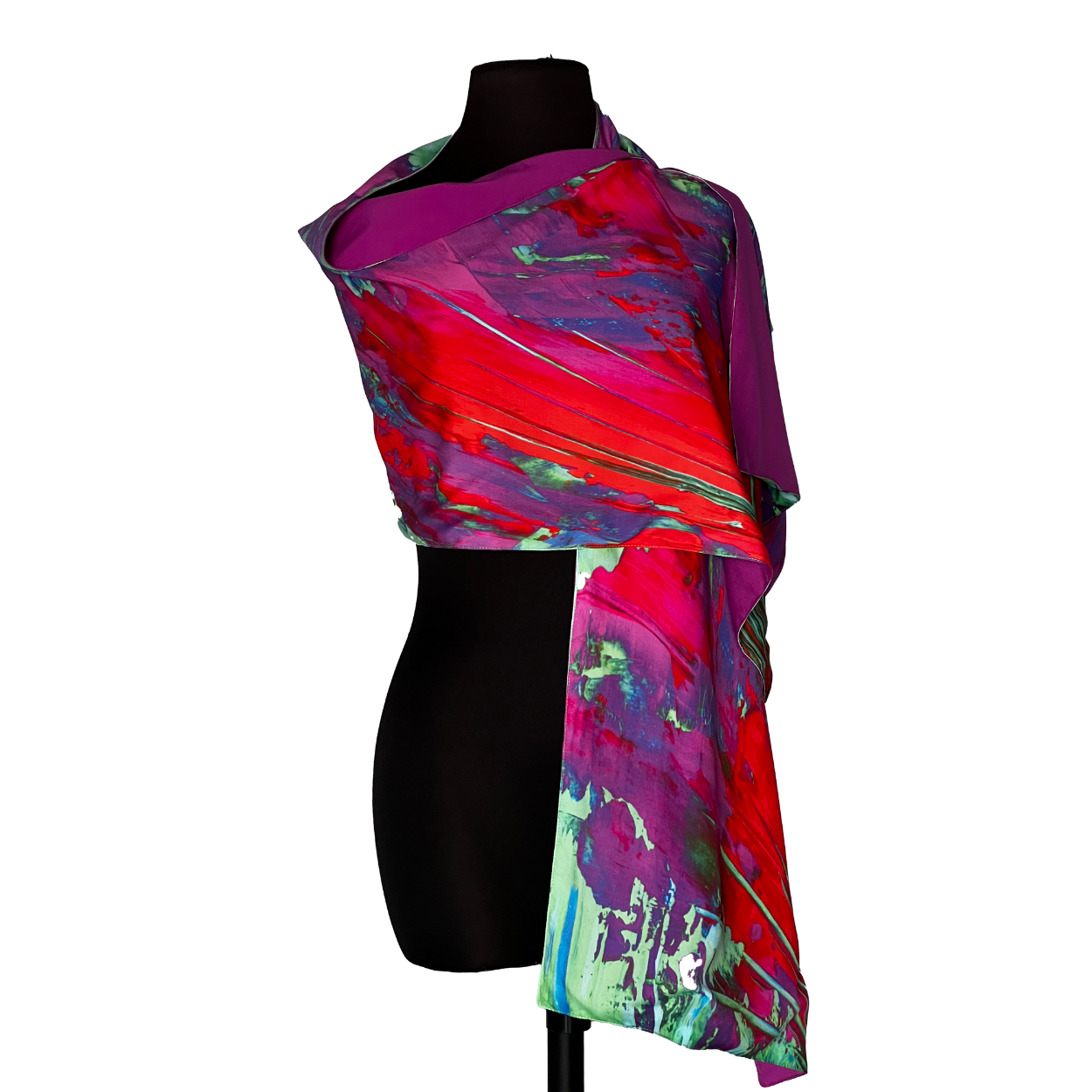 Purple, red, and teal abstract print scarf draped on a black mannequin.