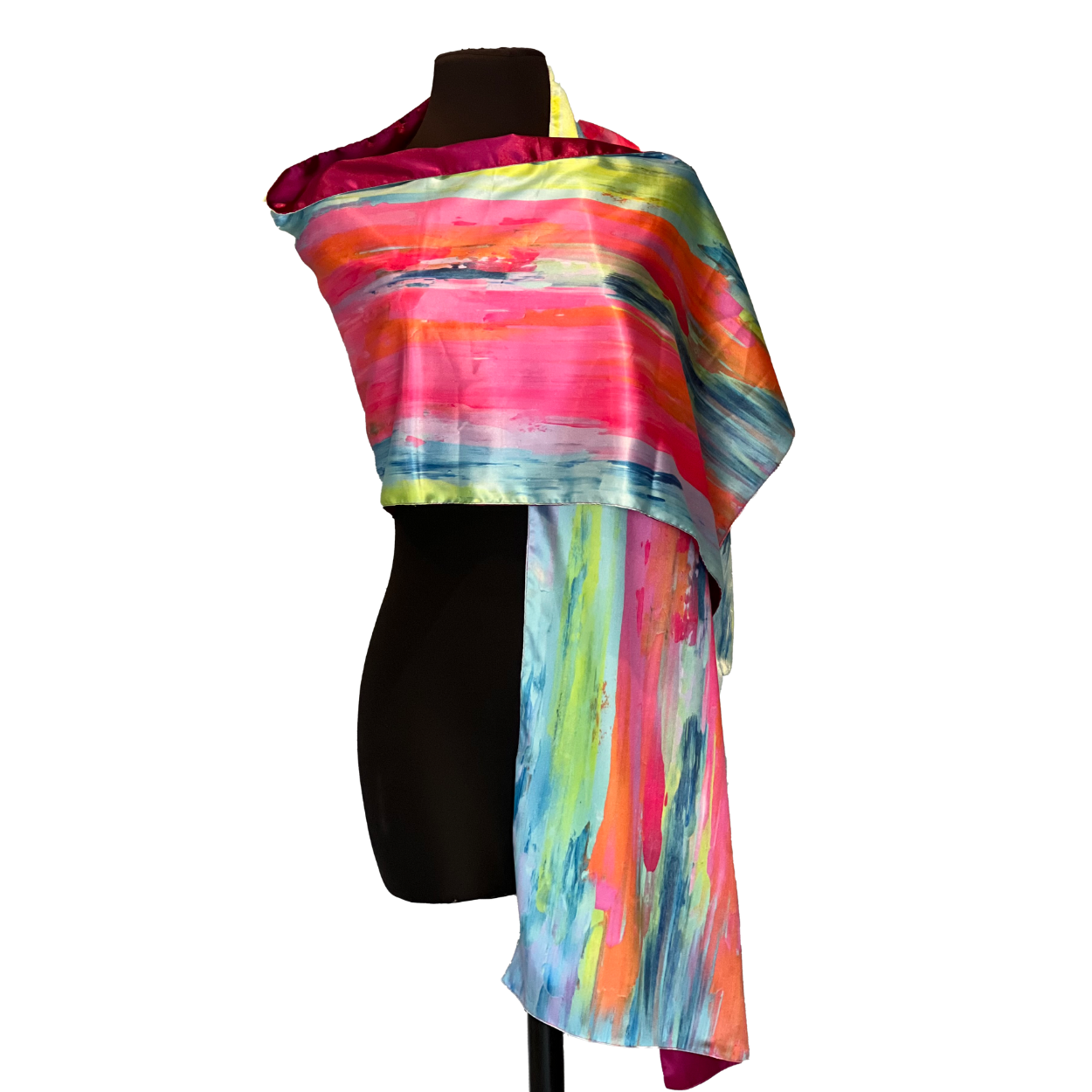 Colorful silk scarf draped over a black mannequin, with bold strokes of pink, blue, yellow, and orange.