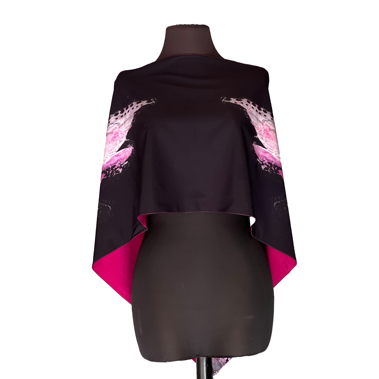 Black cape with pink feather design on a mannequin.