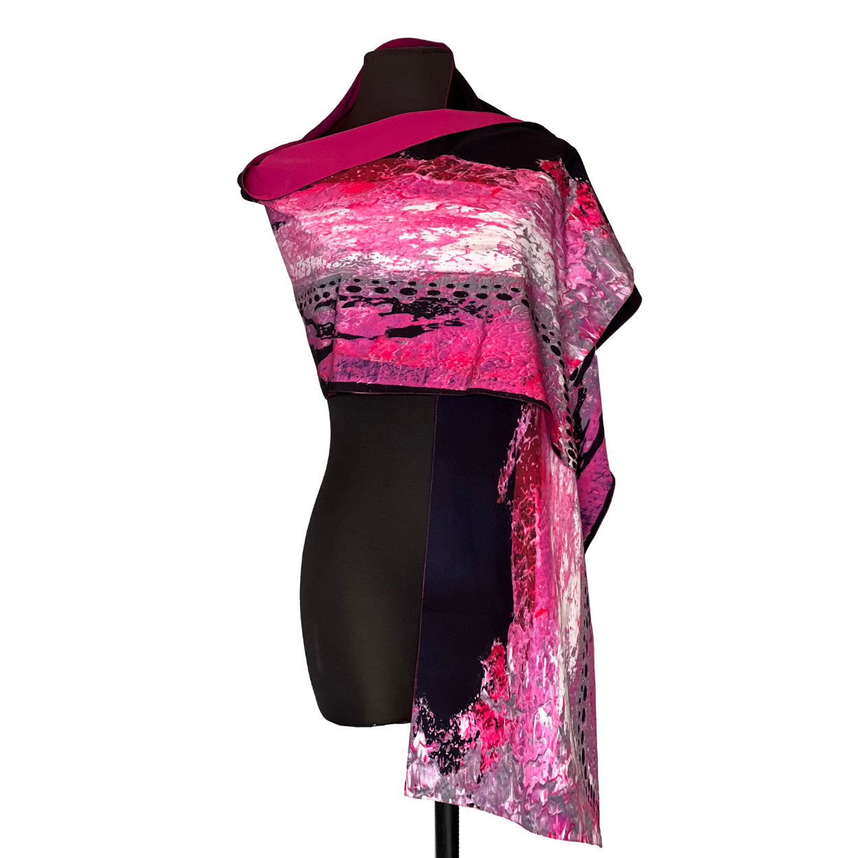 Pink, black, and gray patterned silk scarf draped on a mannequin, with bold abstract design.