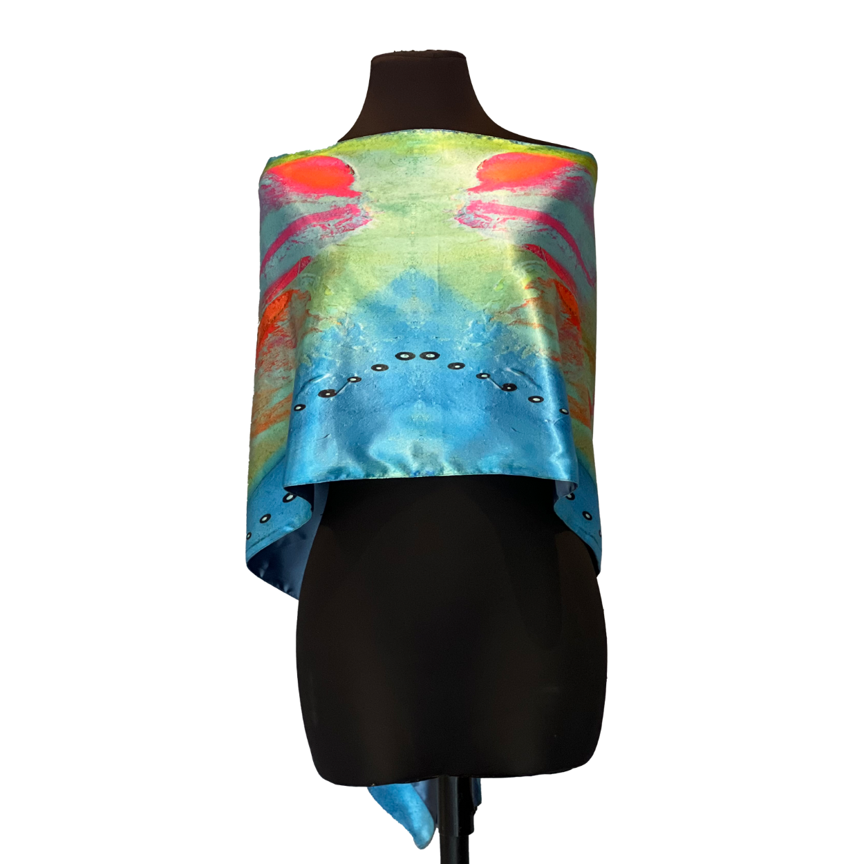 Silk scarf with blue, green, and orange abstract pattern, draped on a black mannequin.