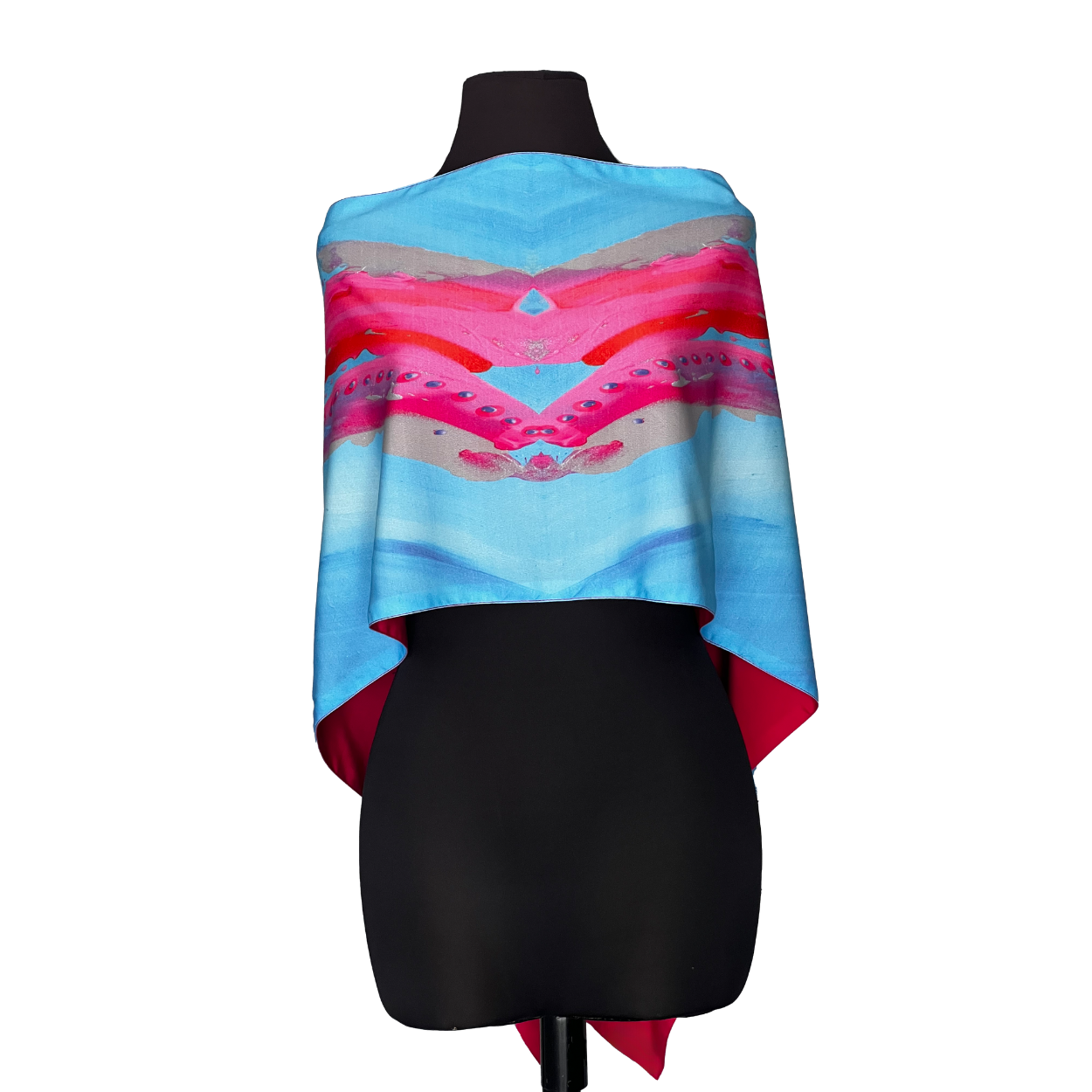 Blue, pink, and red patterned shawl draped over a black mannequin.