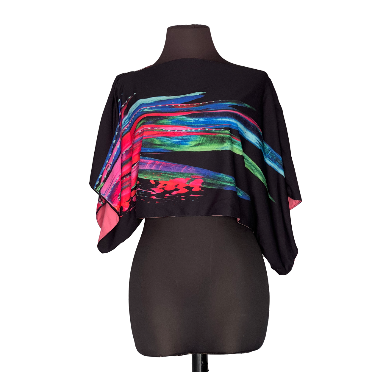 Black crop top with colorful, brushstroke design on a mannequin.
