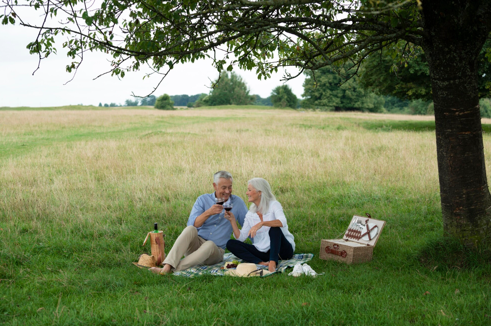 New York City skyline at sunset with orange and yellow sky over buildings.