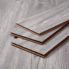 Three pieces of wood are stacked on top of each other on a wooden floor.