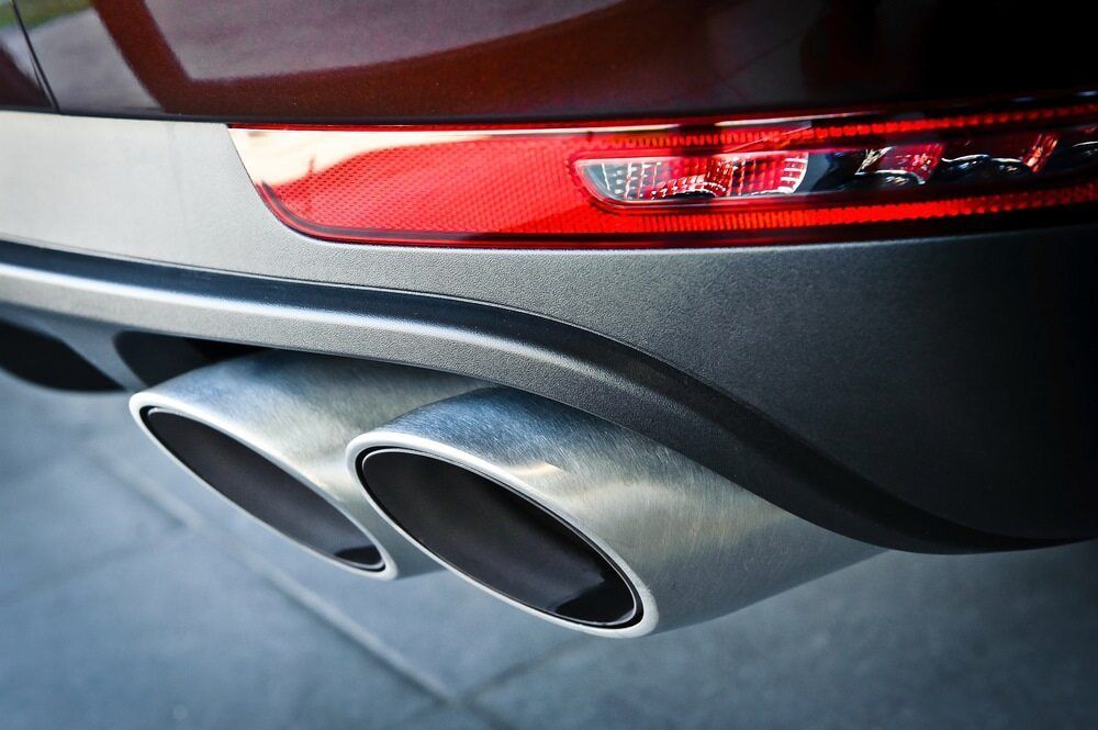 A Close up Of a Car 's Exhaust Pipe and Tail Light — Tweed Exhaust & Mechanical In Tweed Heads South, NSW