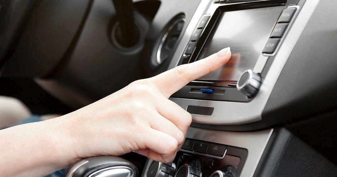 Woman selecting music while in her car