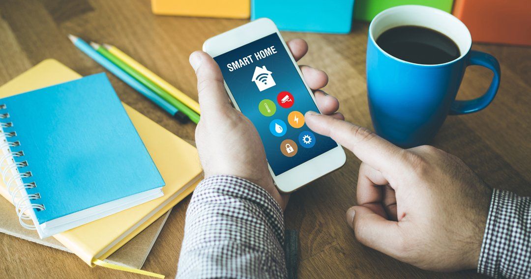 Man controlling his smart home lights from his workplace