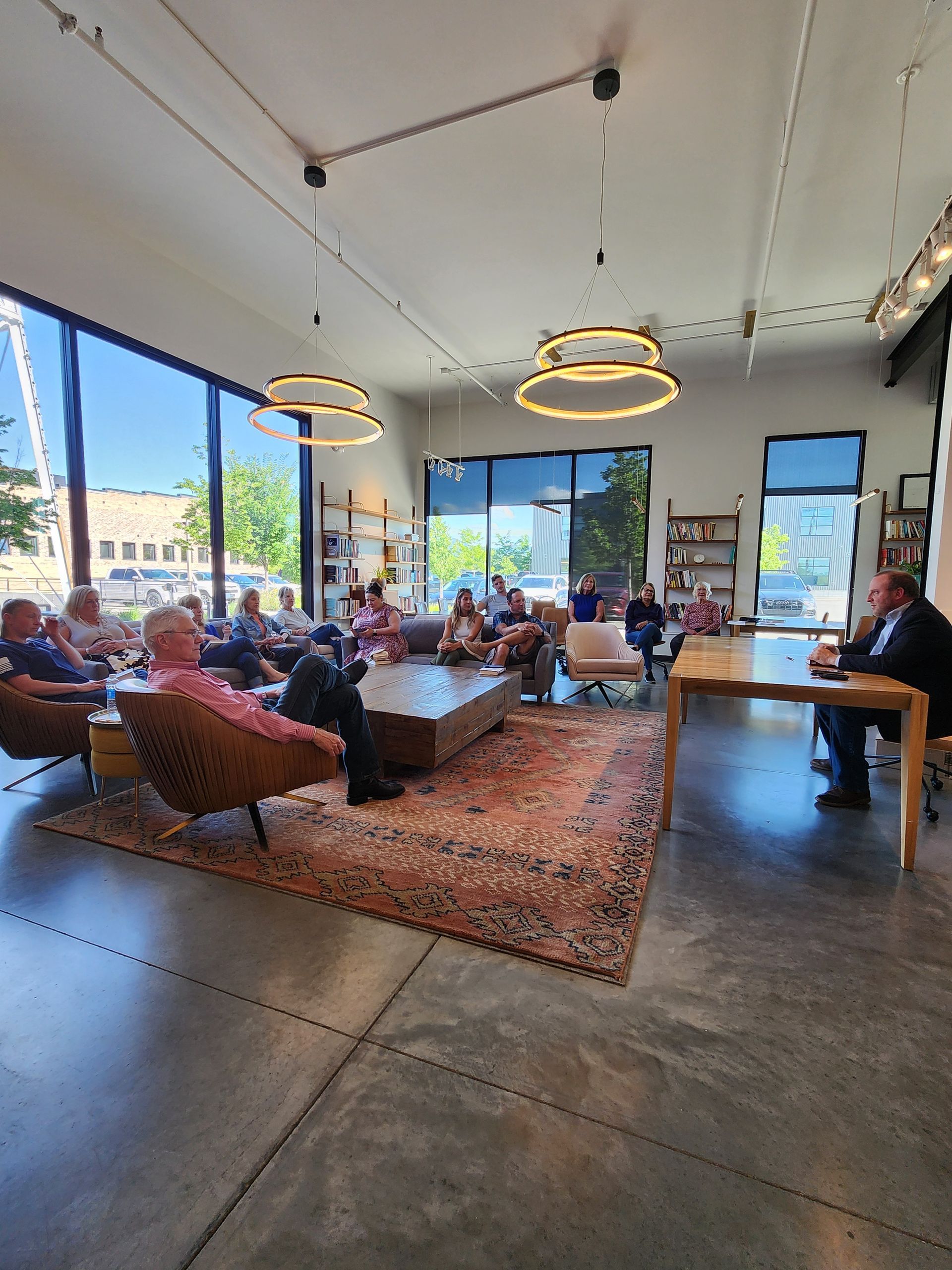 A group of people are sitting in a living room.