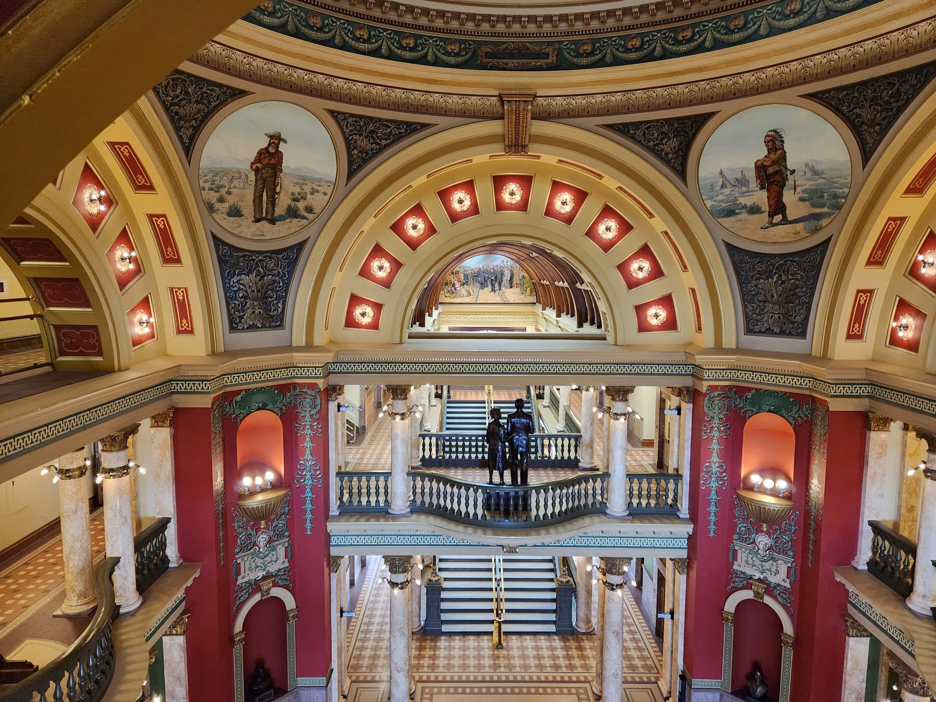 The inside of a building with a dome and stairs