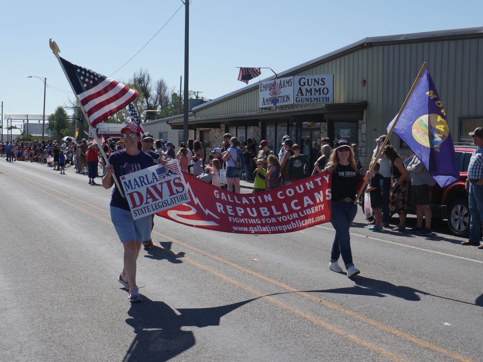 A group of people are marching down a street in a parade.
